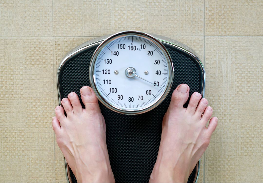 Feet on a scale — tracking weight loss results
